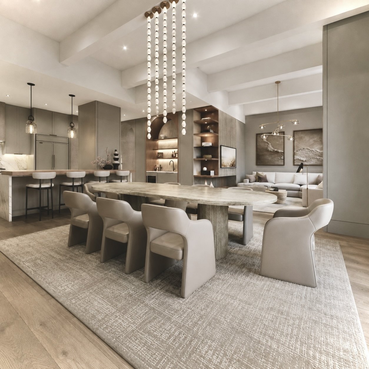 Open dining room of a combined Hoboken loft with stone dining table, cascading glass pendant lighting, and kitchen beyond