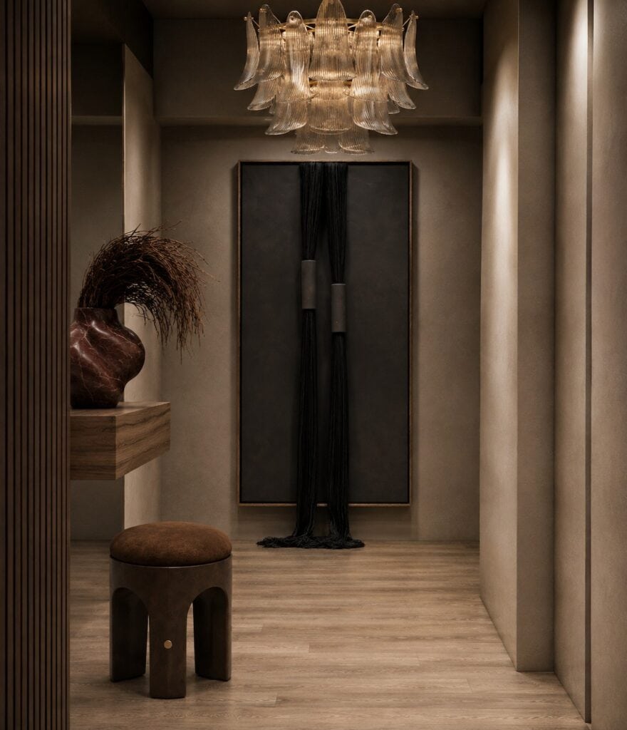 Entry hall with a glass petal chandelier, a fluted wood screen and a black fiber artwork in a Brooklyn tower.