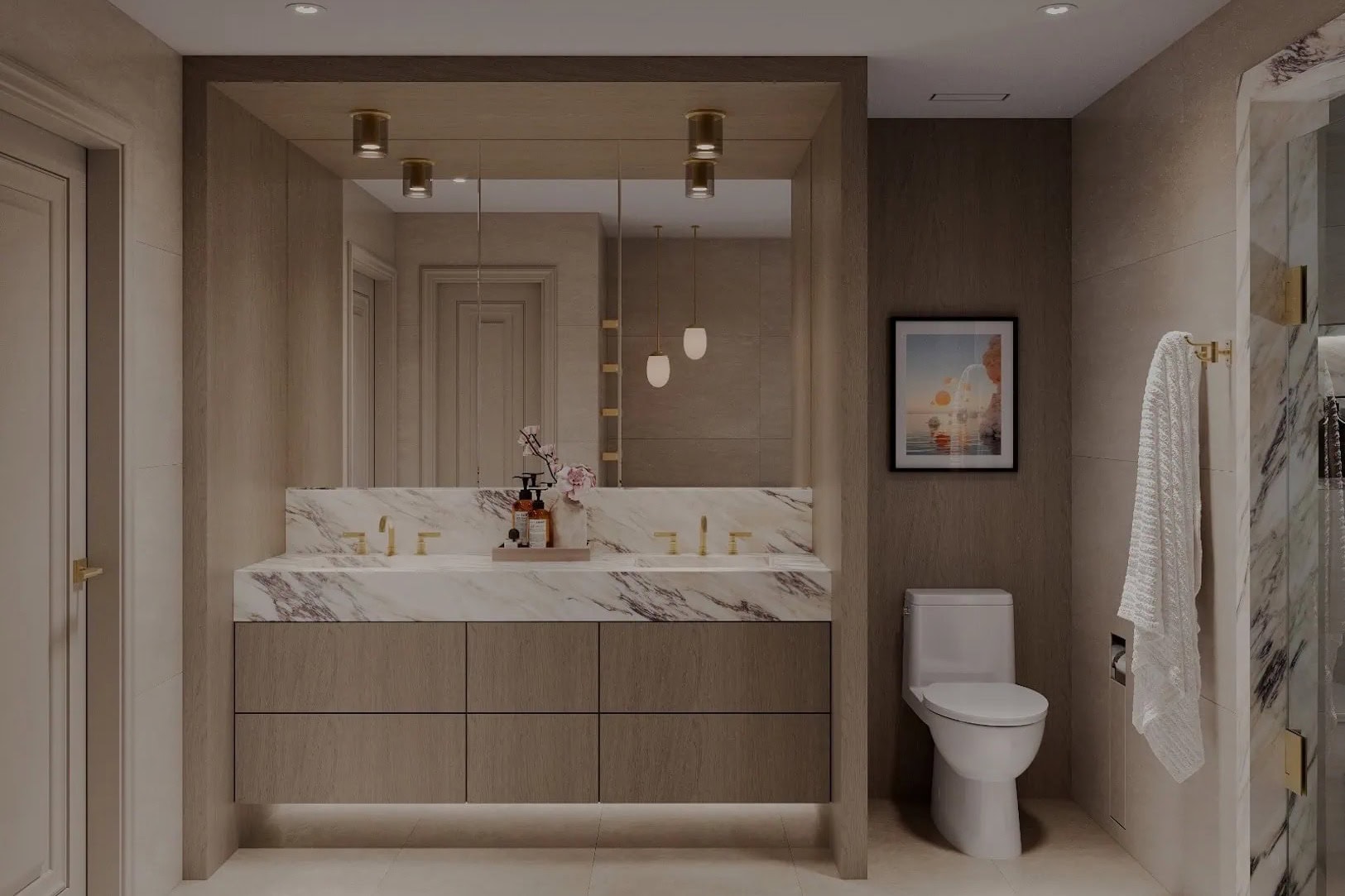 Double vanity with veined marble counters, oak cabinetry and brass fittings in a Hoboken waterfront condo bathroom.